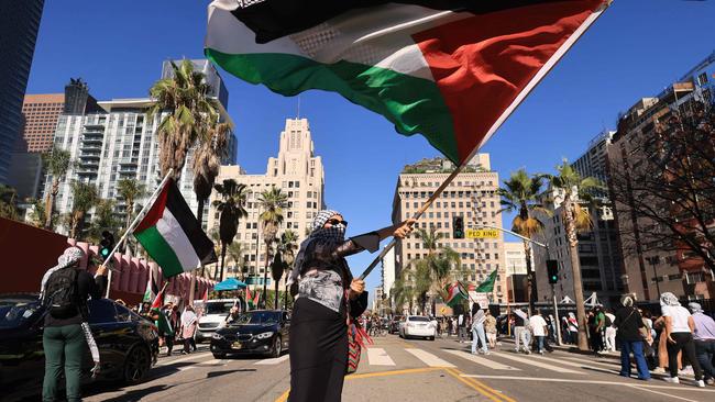 A protestor waves a Palestinian flag as people rally in support of Palestinians in Los Angeles, California on October 21, 2023, amid ongoing conflict between Israel and Hamas. (Photo by DAVID SWANSON / AFP)