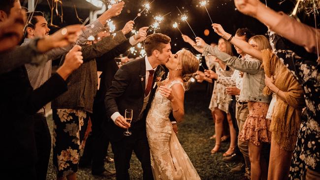 Isaac and Carla Knight enter their wedding dance through a sparkler tunnel at Laloli, Little Mulgrave. Picture: Perspectives Photography