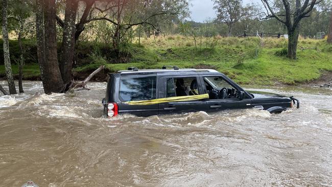 Three people have been rescued by a police officer after they became trapped in their car by floodwaters in the state’s Hunter Region today. Picture: PMU