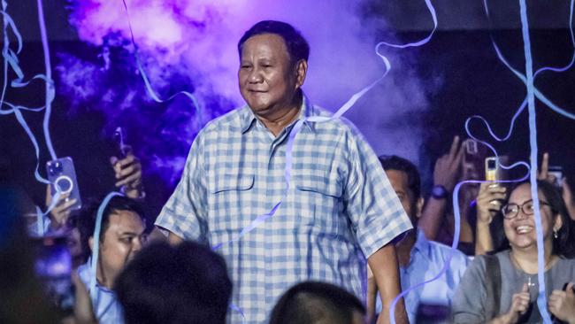 Prabowo Subianto, who has claimed victory in the Indonesian presidential election, dances on stage during a gathering with supporters after polls closed on Wednesday. Picture: AFP