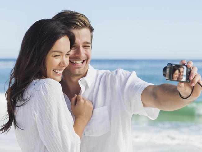 Happy couple taking a photo on a beach on holidaysFeeling Great - June 22nd.