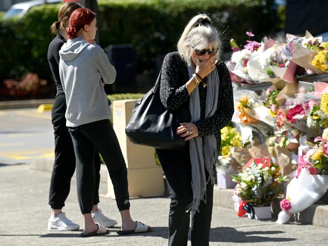 SYDNEY, AUSTRALIA - NewsWire Photos, April 15, 2023: Members of the community arrive to lay a floral tribute where paramedic Steven Tougher was killed on Friday.Picture: NCA NewsWire / Jeremy Piper