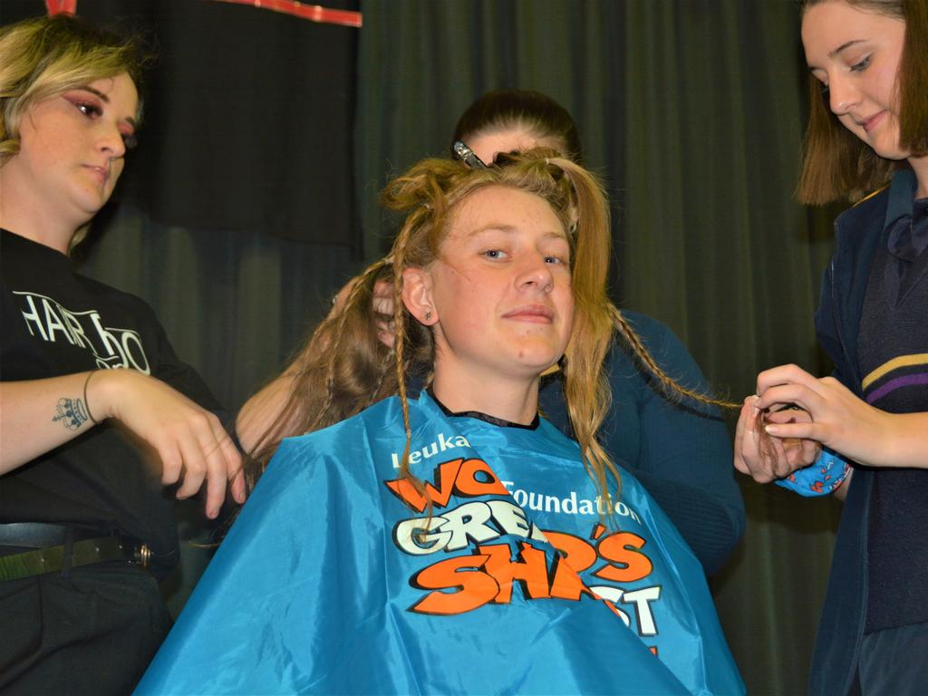 At the St Joseph's College 2023 World's Greatest Shave event is student Emily Chandler getting her hair cut by her support crew and hairdresser Natalie Schmidt from the Hair Room on Russell. Picture: Rhylea Millar