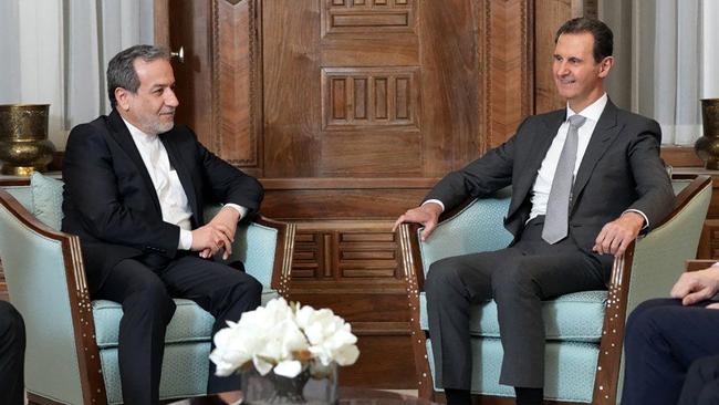 Iran's Foreign Minister Abbas Araghchi (L) meets with with Syrian President Bashar al-Assad (R) in Damascus, after the lighting advance by rebels.