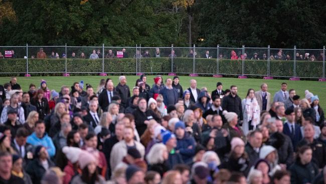 Locked-out Victorians look on at the Dawn Service from behind a fence. Picture: Asanka Ratnayake/Getty Images