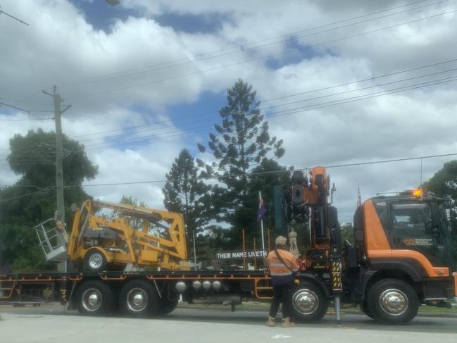 Workers load a crane onto a truck following an earlier crash on Brisbane Rd at Bundamba.