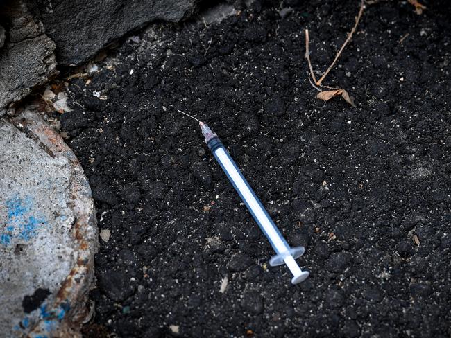 A syringe dumped near the Regal entrance.