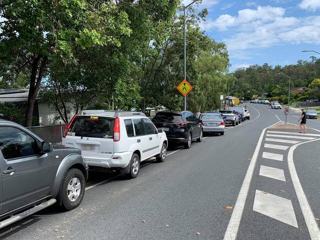 Cars lining up near the 'kiss and go' zone at Helensvale State School.