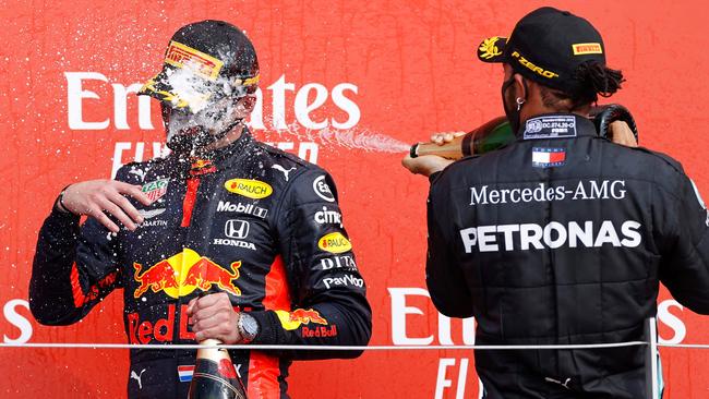 Lewis Hamilton sprays champagne at Max Verstappen after the race. Picture: AFP