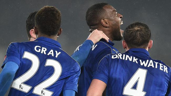 Leicester City's English-born Jamaican defender Wes Morgan (C) celebrates.