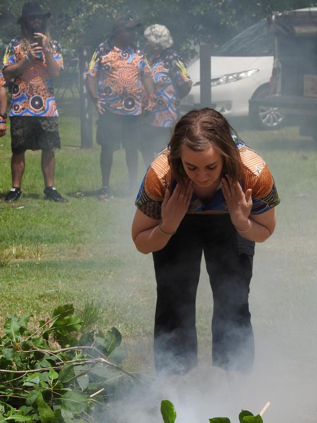 Minna Davis, the new Yarrabah Primary School teacher, participates in a traditional smoking ceremony as a Welcome to Country on Survival Day at Yarrabah. Picture: Peter McCullagh