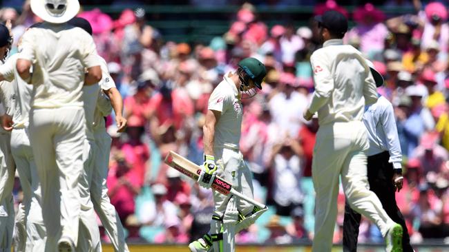 Australia's Steve Smith (C) walks off as England celebrate his dismissal.