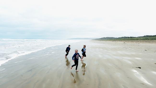 STORM CHILDREN: Damin, 9, Alana 6, and Liam, 8, play on a stormy day at Goolwa Beach. The sequel to classic childhood tale Storm Boy is being made in the area. Picture: Bernard Humphreys