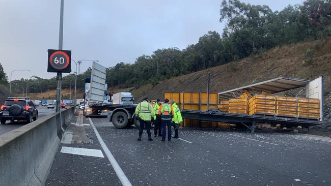 The chicken truck jackknifed, then overturned, blocking three lanes of traffic. Picture: AAP / Emma Brasier