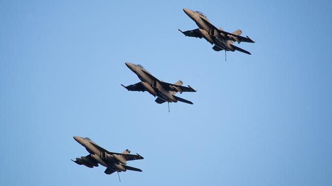 Three US F/A-18 Super Hornets fly over the USS Gerald R. Ford's flight deck in the eastern Mediterranean. Picture: US Navy / AFP