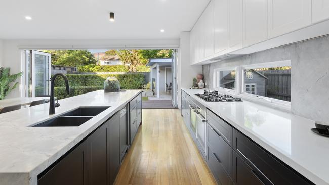 The kitchen is fitted with Neff appliances, including a five-burner gas cooktop and two ovens, and a butler’s pantry.