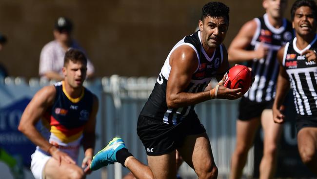 Port Adelaide’s Lindsay Thomas gathers the ball and heads forward. Picture: Tom Huntley