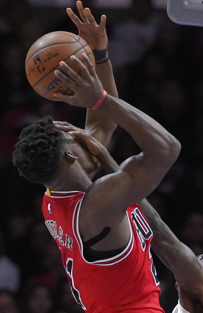 Chicago Bulls guard Jimmy Butler gets a hand in the face by LA Clippers guard Jamal Crawford.