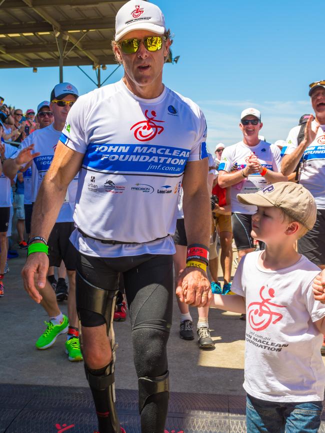 John crosses the finish line with his family. (JGRimages)