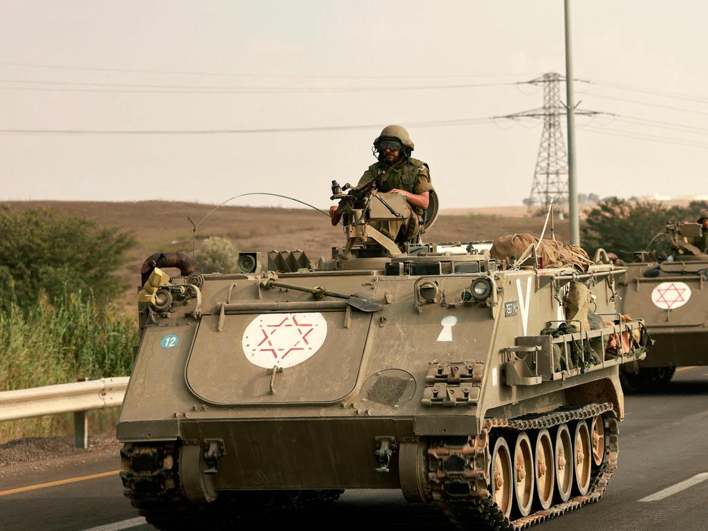 Israeli soliders ride in their armoured vehicles towards the border with the Gaza Strip. Picture: AFP