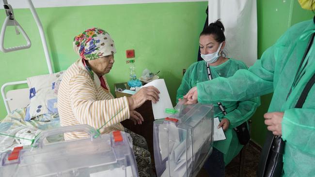 A woman casts her ballot for a referendum at a hospital in Berdyansk.