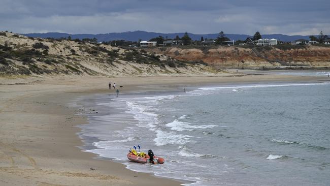 Police and surf rescue search the area for a shark after a man swimming was attacked at Port Noarlunga Beach on Thursday. Picture: Mark Brake