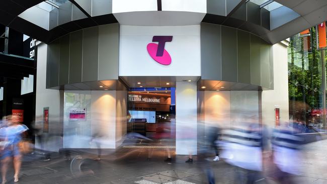 Pedestrians walk past a Telstra Corp. Discovery store in Melbourne, Australia, on Tuesday, Feb. 9, 2016. Telstra, Australia's biggest phone company, is scheduled to report half-year results on Feb. 18. Photographer: Carla Gottgens/Bloomberg