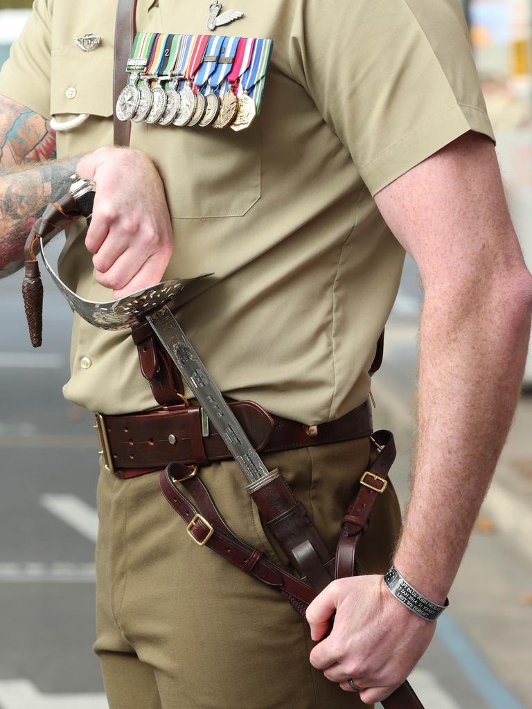 Major Andrew Evans honoured his late friend Capt Paul McKay by carrying his sword in today’s Anzac Day march. Picture: Russell Millard