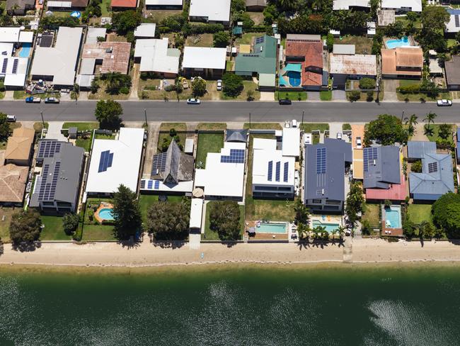 Solar panels on suburban waterfront homes.