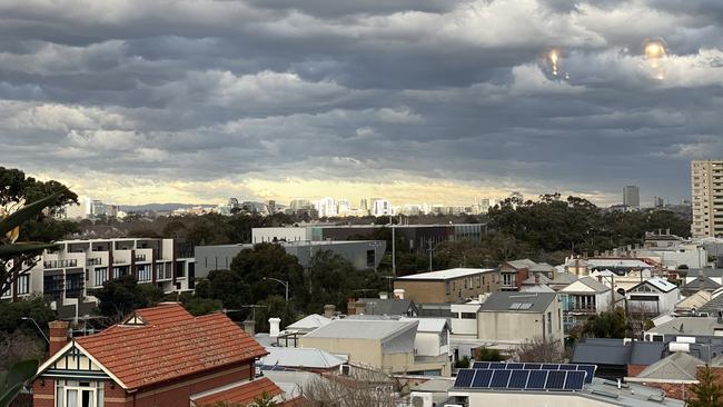 Albert Park with a sunlit St Kilda Road in the background as the storm rolled in yesterday. Picture: Tracey Stephenson