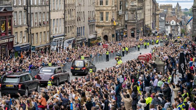 The hearse carrying the coffin of Queen Elizabeth II, draped with the Royal Standard of Scotland, passes down the Royal Mile, Edinburgh, on the journey from Balmoral to the Palace of Holyroodhouse on Monday morning (AEST). Picture: Getty Images