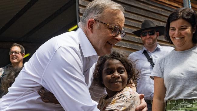 EAST ARNHEM, AUSTRALIA - AUGUST 05: Australian prime Minister Anthony Albanese embraces a young Yolngu child during Garma Festival 2022 at Gulkula on August 05, 2023 in East Arnhem, Australia.  The annual Garma festival is held at Gulkula, a significant ceremonial site for the Yolngu people of northeast Arnhem Land about 40km from Nhulunbuy on the Gove peninsula in East Arnhem. The festival is a celebration of Yolngu culture aimed at sharing culture and knowledge which also brings politicians and Indigenous leaders together to discuss issues facing Australia's Aboriginal and Torres Strait Islander people. The gathering takes on a special significance in 2023 with a constitutional referendum on the Voice to Parliament to be held later in the year. (Photo by Tamati Smith/Getty Images)