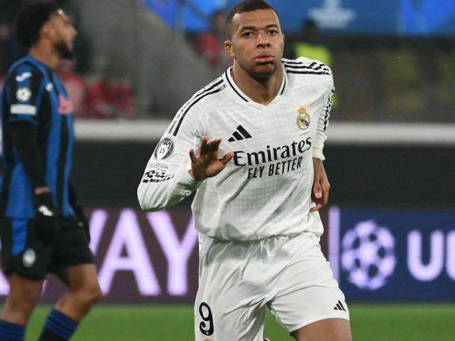 TOPSHOT - Real Madrid's French forward #09 Kylian Mbappe celebrates his team's first goal during the UEFA Champions League football match between Atalanta and Real Madrid at the Gewiss Stadium in Bergamo, on December 10, 2024. (Photo by Alberto PIZZOLI / AFP)