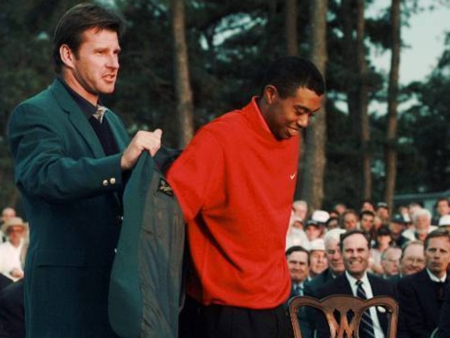 In this April 13,1997, file photo, Tiger Woods, 1997 Masters champion, receives his Green Jacket from the previous year's winner Nick Faldo.