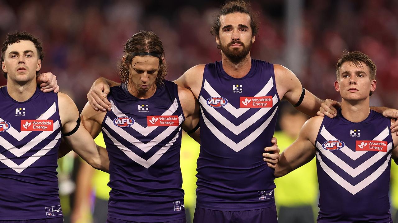 Jordan Clark, Nat Fyfe, Alex Pearce and Caleb Serong of the Dockers line up as the teams pay their respects to Cam McCarthy (Photo by Paul Kane/Getty Images)