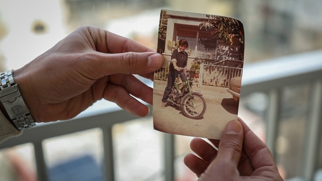 Sami Hayek holds a photo of his mother in Tyre — the only possession he could rescue from her home. Picture: Oliver Marsden/The Times