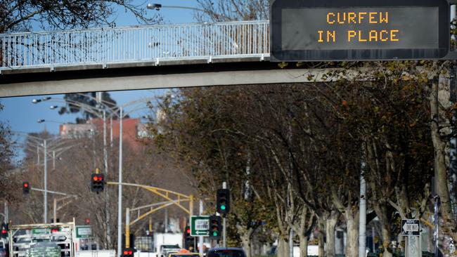 A curfew sign on Hoodle Street at Collingwood on Monday as the lockdown bites. Picture: Andrew Hensaw/NCA NewsWire/Andrew Henshaw