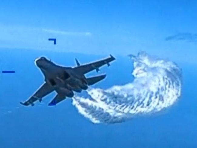 SEVASTOPOL, UKRAINE - MARCH 14: In this screengrab of a video clip released by the United States Defense Department's European Command, a Russian Su-27 fighter jet flies near an American MQ-9 Reaper drone, spraying what the US government says is jet fuel, on March 14, 2023 over the Black Sea near Crimea. On a final pass, the Russian jet allegedly collided with the drone, damaging its propeller, forcing it to be brought down in the Black Sea. (Photo by US Defense Department European Command via Getty Images)