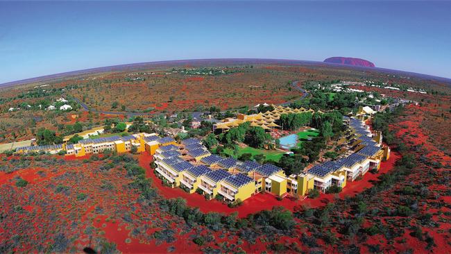 An aerial shot of Ayers Rock Resort with Uluru in the background. Picture; Voyages Tourism Australia