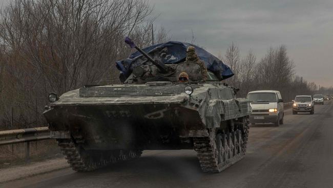 Ukrainian soldiers ride on an armoured military vehicle in Lyman district, Donetsk region, on Sunday. Picture: AFP