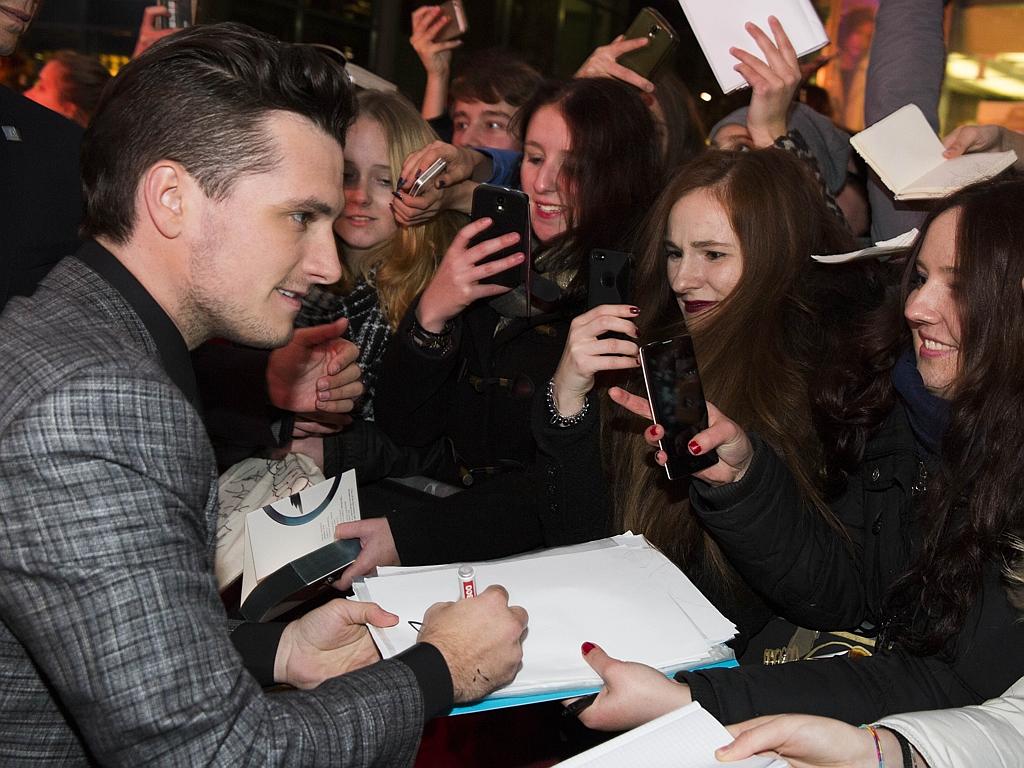 Actor Josh Hutcherson signs autopraphs for fans as she arrives at the world premiere of the film ‘The Hunger Games: Mockingjay - Part 2’ on November 4, 2015 in Berlin. Picture: AP