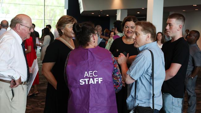 New citizens talk to electoral commission staff at the event. Picture: Colin Murty