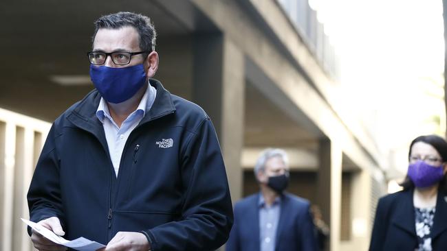 Premier Daniel Andrews, Victorian Chief Health Officer Brett Sutton and Heath Minister Jenny Mikakaos wear face masks as they walk to the daily briefing on Sunday. Picture: Getty