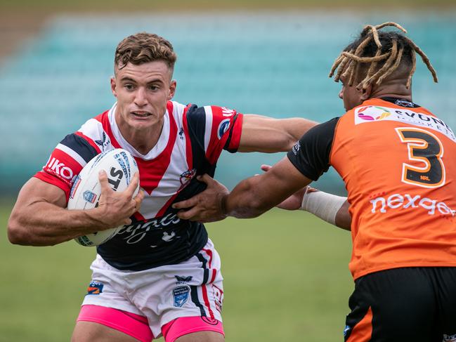 Xavier Tauaifaiga is palmed off by Roosters player Zac Sarfati. Picture: Julian Andrews