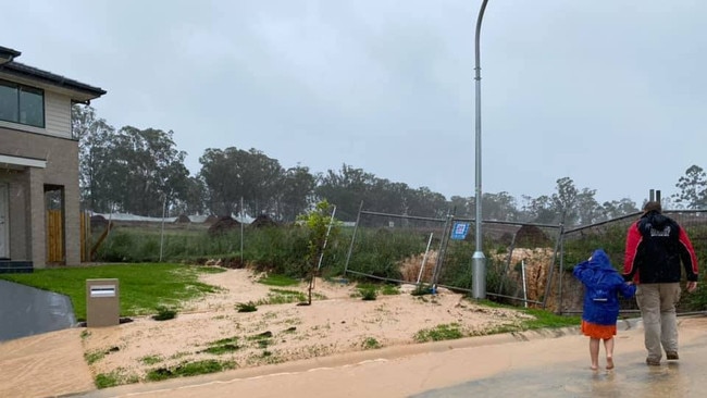 The sinkhole, which has been fenced off, is just metres from brand new homes.