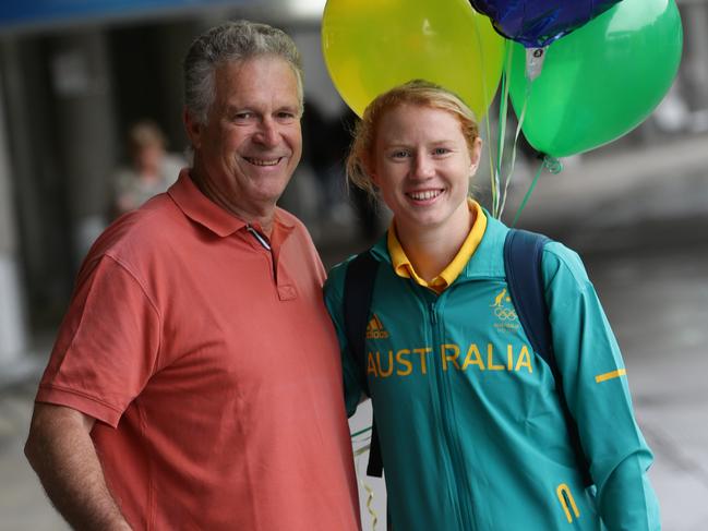 Clare Polkinghorne with her father Tony after arriving back in Brisbane following the 2016 Rio Olympics. Pic Peter Wallis