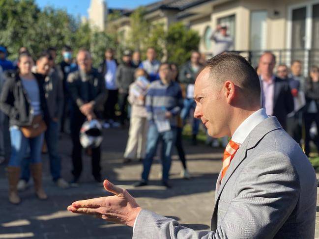 Auctioneer Andrew Cooley receives bids at the auction of a Riverwood house on Saturday, June 20, 2020. NSW real estate.