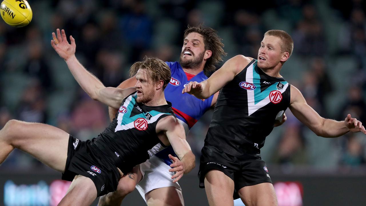 Tom Jonas and Tom Clurey of the Power clash with Josh Bruce of the Bulldogs. Picture: James Elsby/AFL Photos)