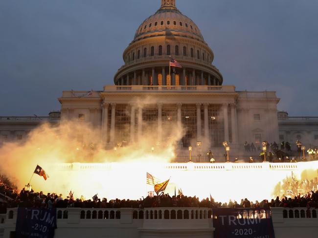 An explosion caused by a police munition is seen while supporters of U.S. President Donald Trump gather in front of the U.S. Capitol Building in Washington, U.S., January 6, 2021. REUTERS/Leah Millis