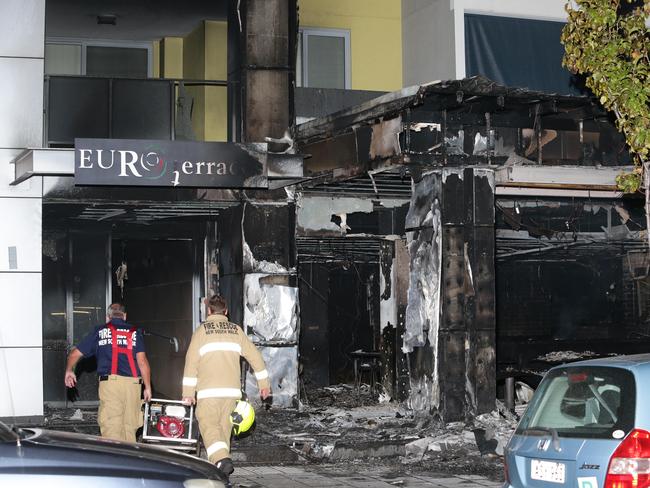 Firefighters inspect the burnt out remains of Rashay's Restaurant on the ground floor of the Euro Terraces building in April 2016. Picture: Bill Hearne